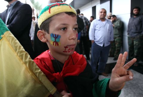 A Berber boy, decorated in the image of the Amazigh flag, takes part in a protest outside government offices demanding recognition of Berber language and culture in Libya's new consitution.