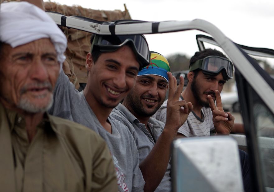 Berber rebels flash victory signs outside a Gadhafi compound in September 2011. Berbers fought fiercely against Gadhafi's forces during the Libyan revolution, driven by four decades of the suppression of their culture under the old regime.