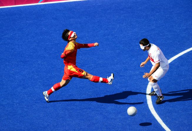 Chinese Zhoubin Wang, left, chases the ball during the men's team football five-a-side match against Turkey.