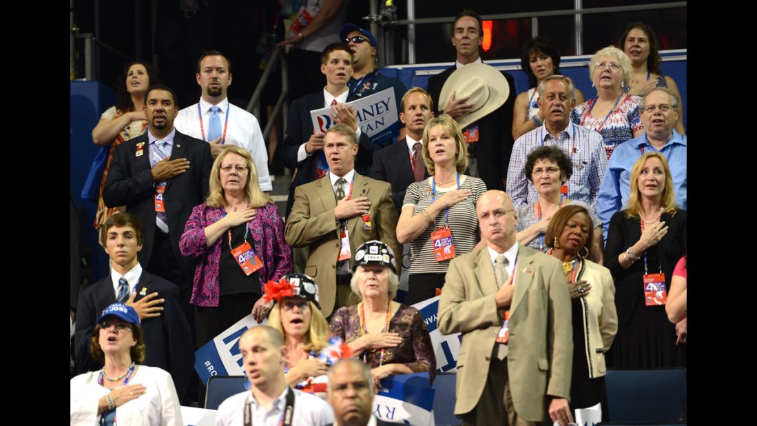 Delegates listen to the national anthem at the Tampa Bay Times Forum.