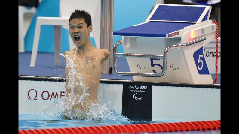 China's Zheng Tao celebrates breaking the world record after winning the men's 100-meter backstroke swimming event.