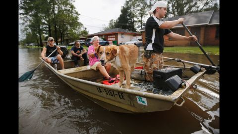 Jewel Rico and her dog Chico are rescued from flood waters from Isaac on Thursday, August 30, in Reserve, Louisiana.
