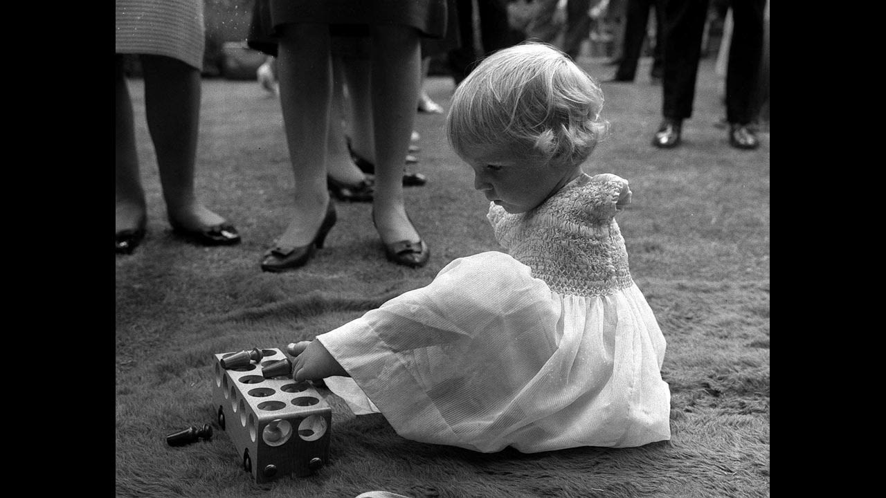 Phillipa Bradbourne uses her feet to play with a toy.