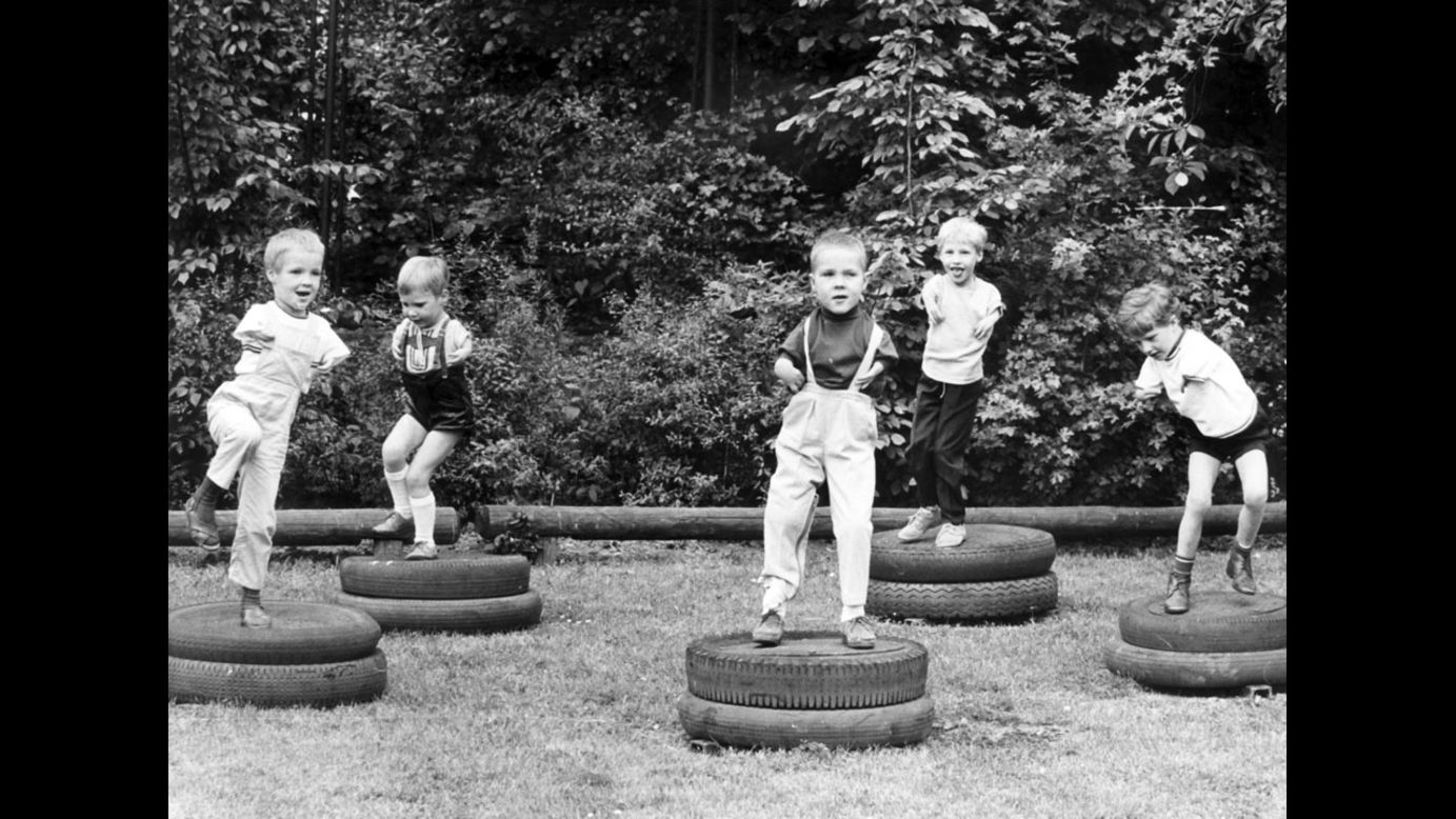 Children affected by Thalidomide jump on tires at the playground of the city run day care center for children suffering from dysmelia in Cologne, Germany, on March 24, 1968.