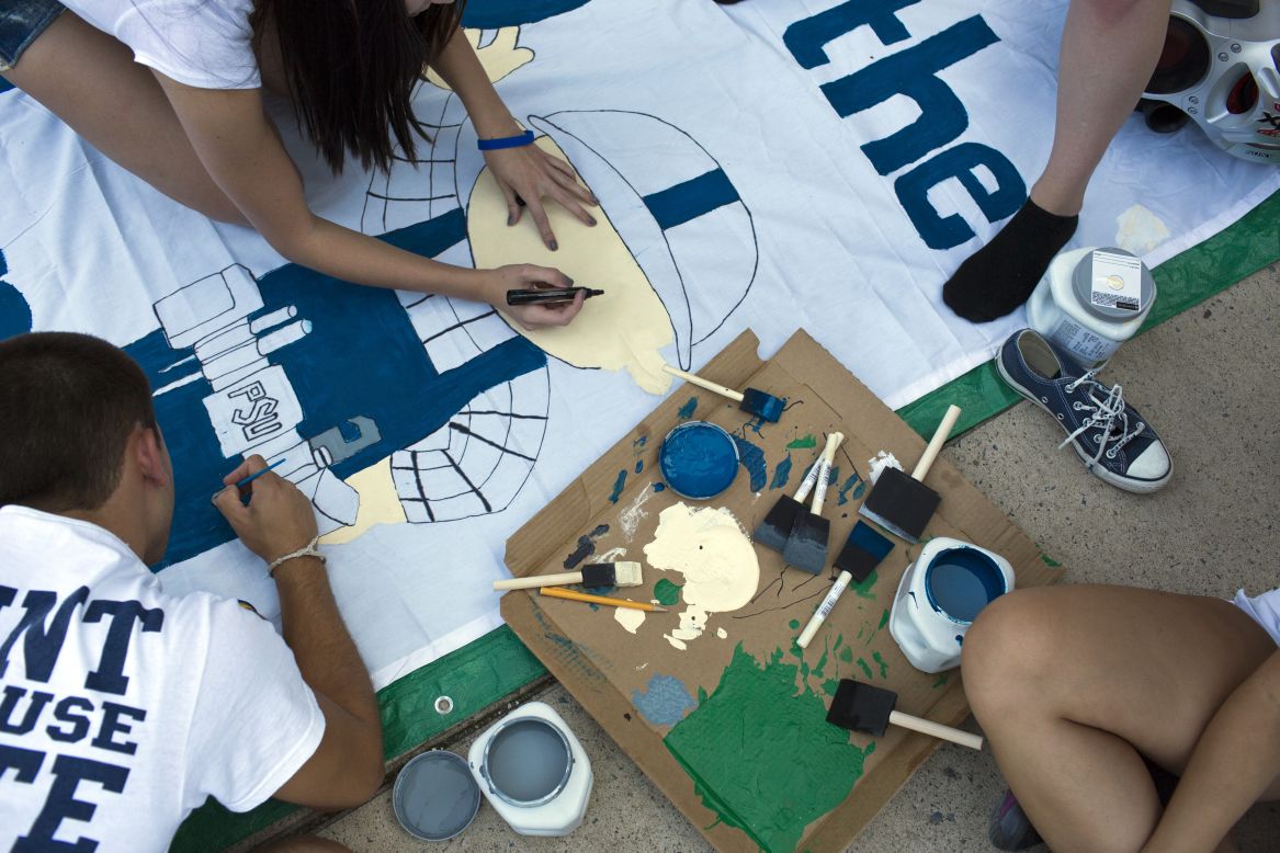 Penn State students work on a banner at "Nittanyville" outside Beaver Stadium in State College, Pennsylvania, on Friday, August 31.