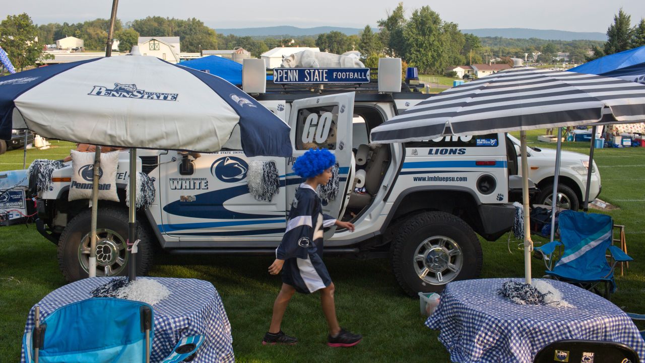 Penn State fan Saya Melo walks through his famiy's tailgating area outside the stadium.