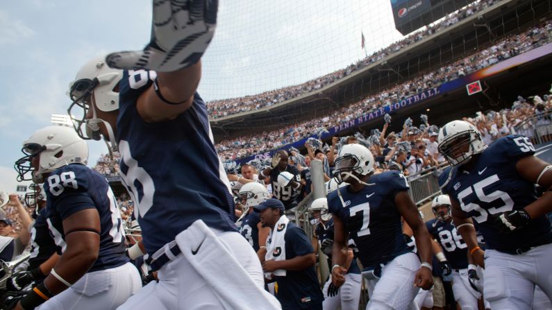 Members of the Penn State football team take the field to play their season opener against Ohio.