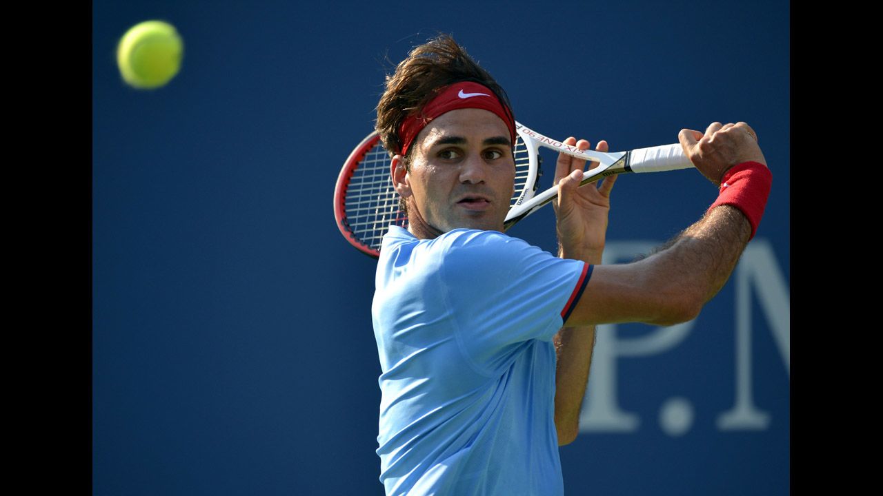 Switzerland's Roger Federer returns a shot to Spain's Fernando Verdasco.