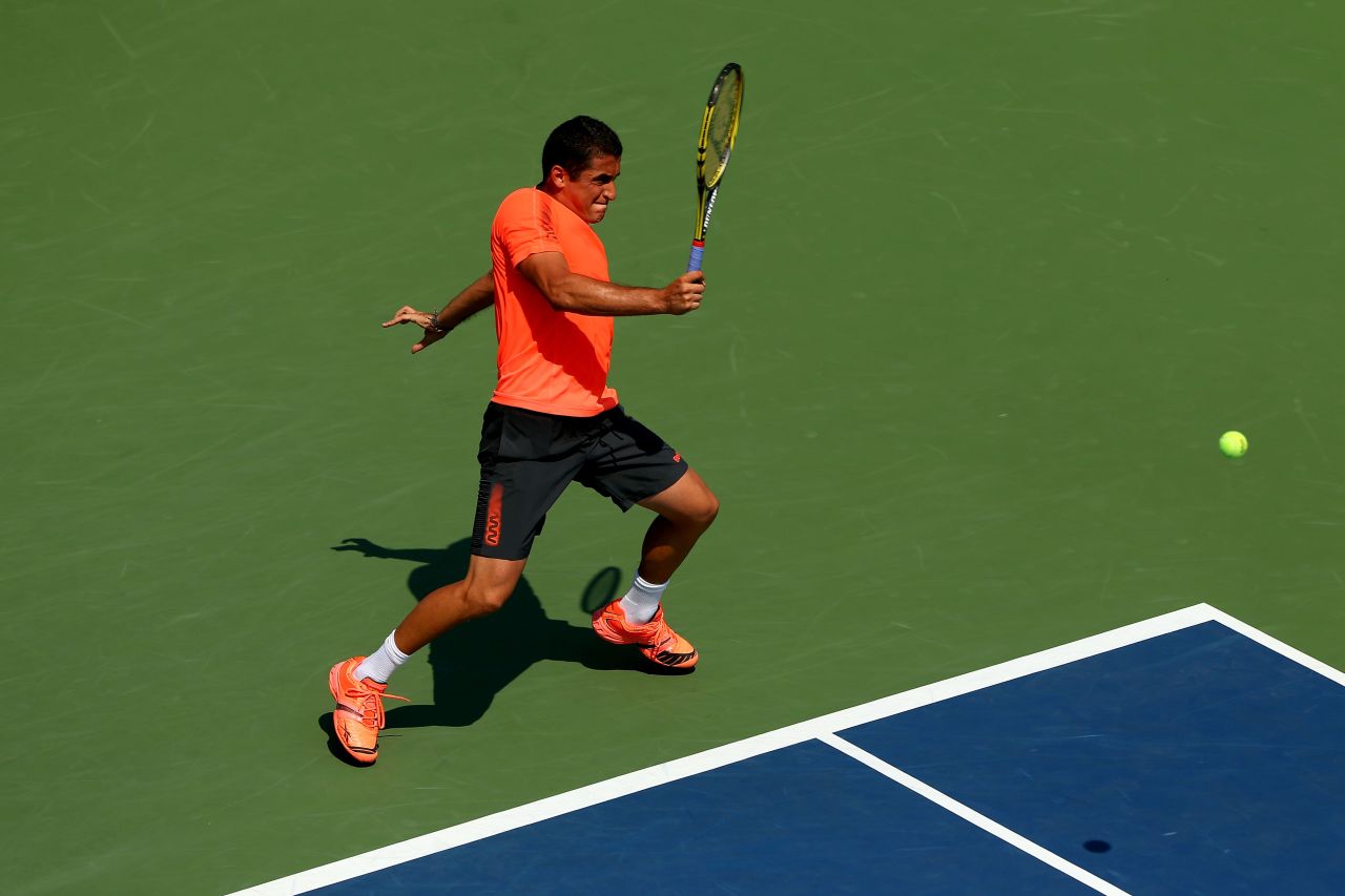 Spain's Nicolas Almagro returns a shot to Jack Sock of the United States.