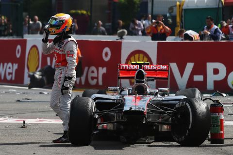 A disgruntled Hamilton gestures in the direction of Grosjean after being taken out in the first corner incident at Spa-Francorchamps.