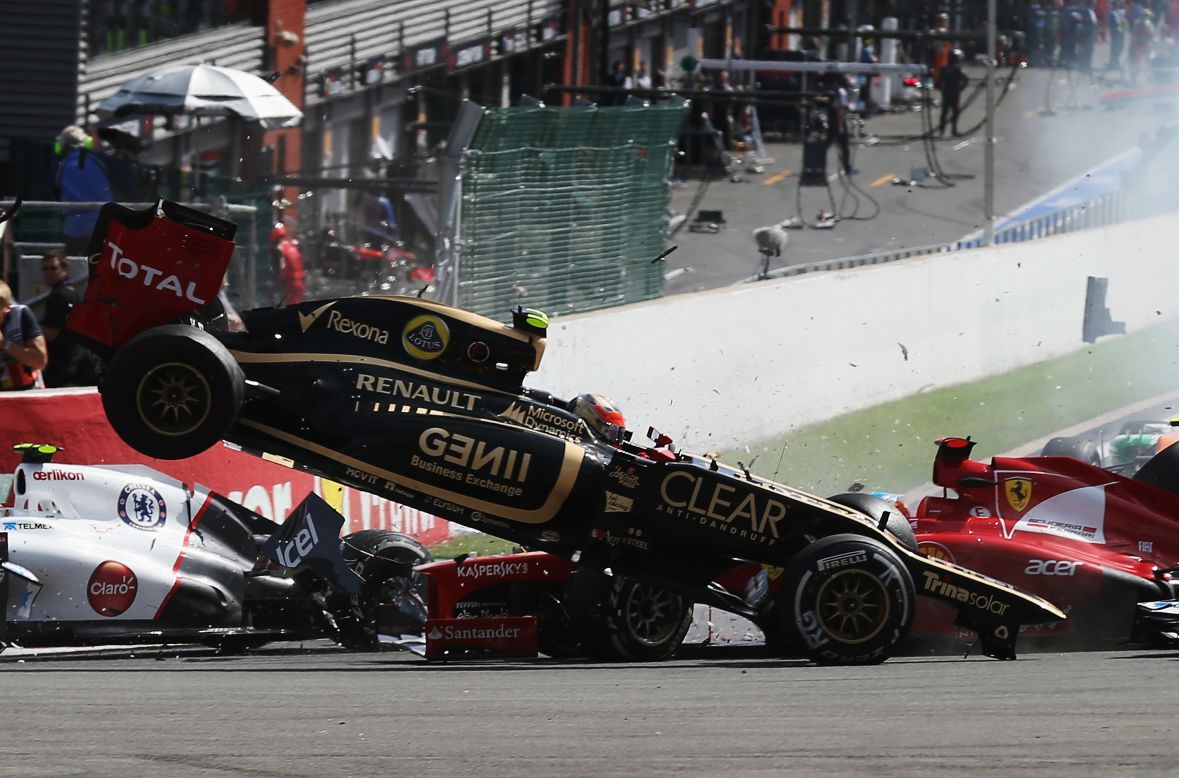 Grosjean in the Lotus has cleared Alonso's front wing and is about the come to ground. 