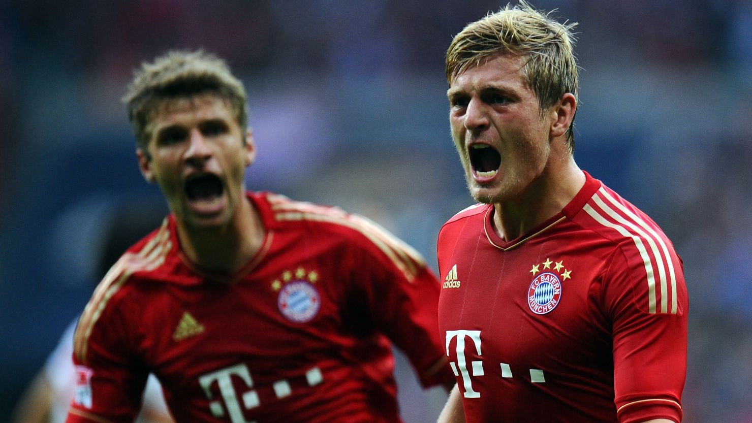 Tony Kroos celebrates scoring Bayern's second goal with help from teammate Thomas Mueller.