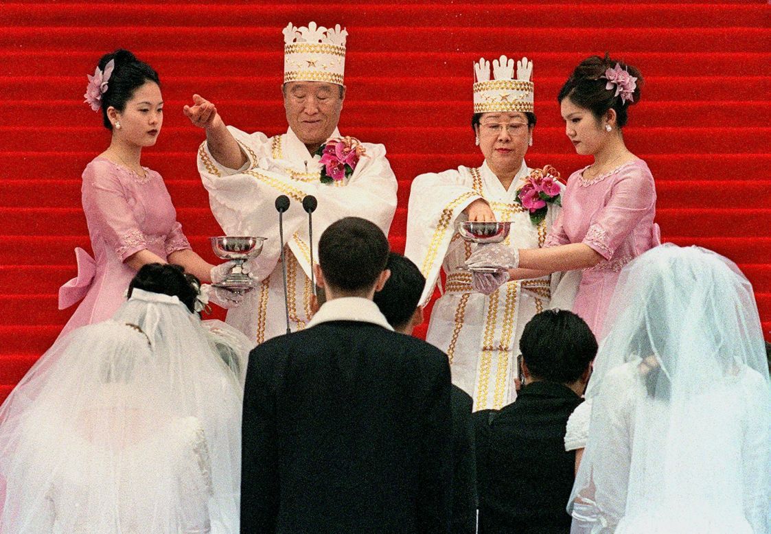 Moon and his wife bless the brides and the grooms during the ceremony in Seoul. Followers of the Unification Church are sometimes referred to as "Moonies."