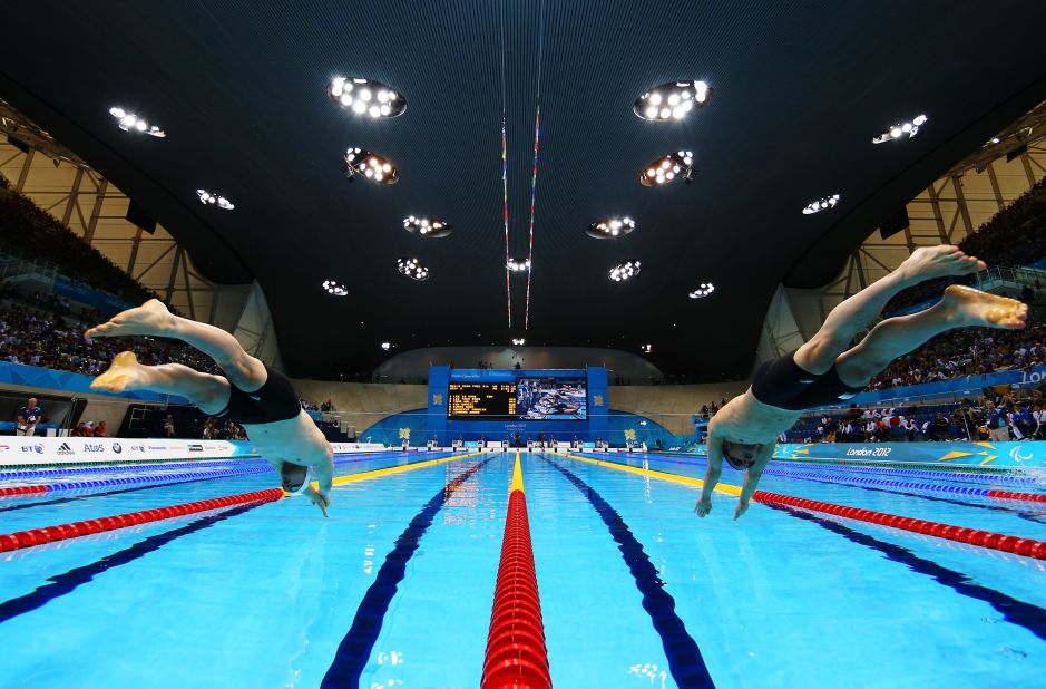 Daniel Fox, left, of Australia and Marc Evers of the Netherlands dive into the pool at the start of the men's 200-meter freestyle - S14 heat 3.