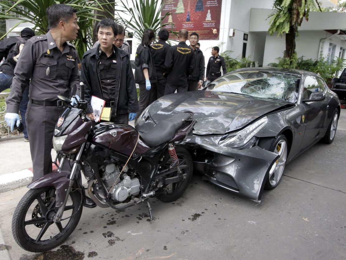 Thai police officers inspect a Ferrari owned by Vorayuth Yoovidhya in Bangkok, in September 2012.