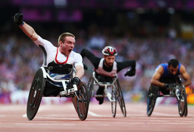 Mickey Bushell of Great Britain crosses the line to win gold in the men's 100-meter final.