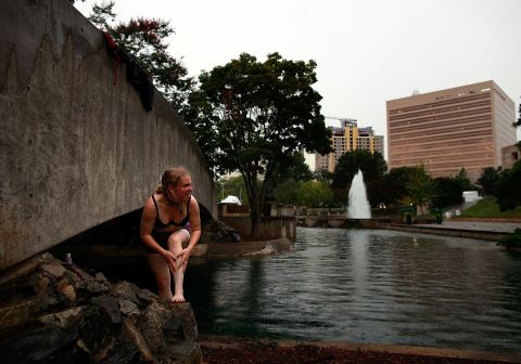 An Occupy protester bathes during a rain shower in Marshall Park in Charlotte on Saturday, September 1. Protesters intend to camp in the city park for the duration of the Democratic National Convention. Up to 70 protest groups are expected in Charlotte.