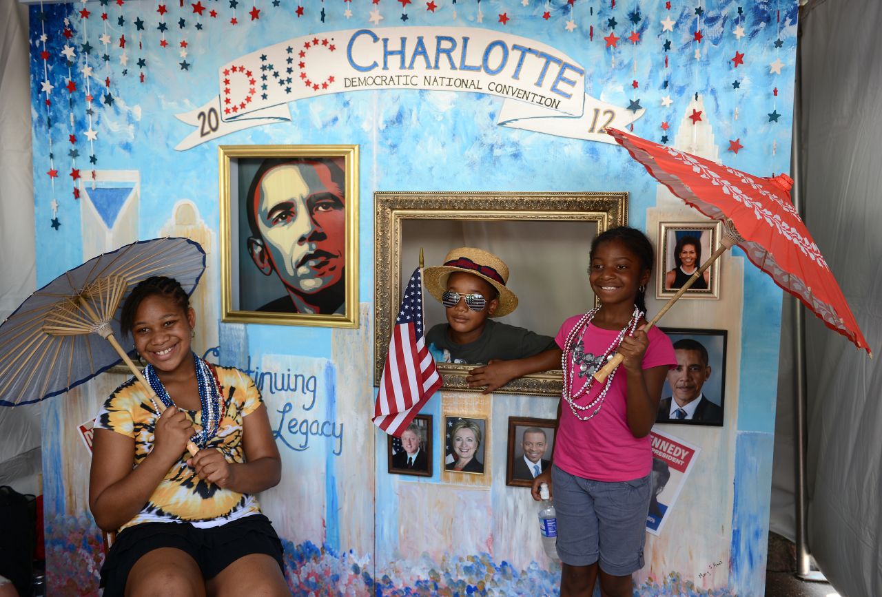 Michah Robinson poses with his sister Simone and cousin Lanise Myers in a souvenir photo booth at the CarolinaFest street festival on Monday.