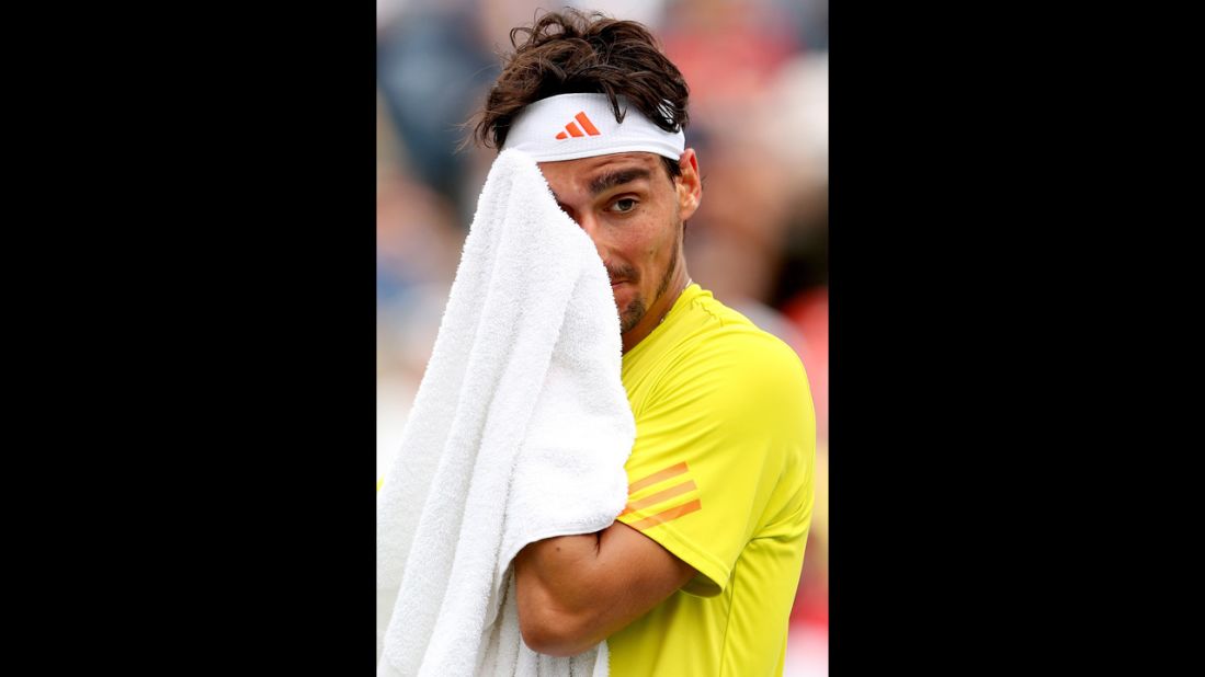 Fognini wipes his face with a towel during his men's singles third-round match against Roddick.