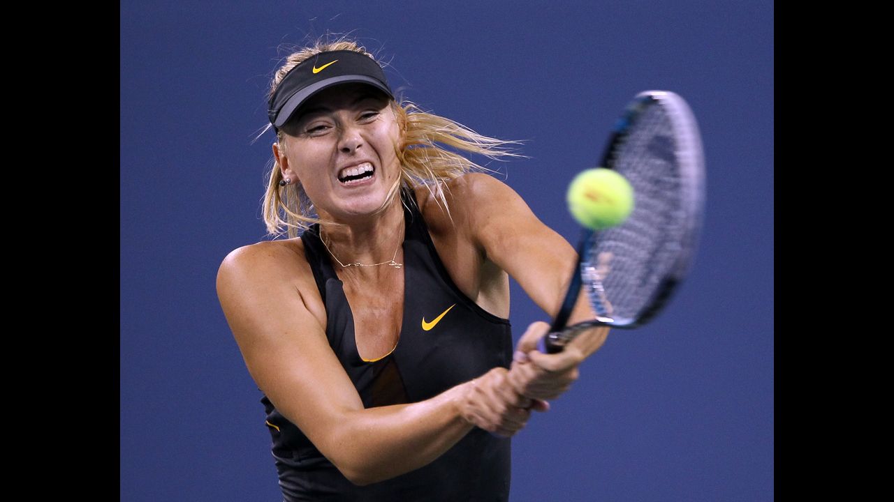 Russia's Maria Sharapova returns a shot to Nadia Petrova of Russia and wins Sunday's match to move on to the quarterfinals.