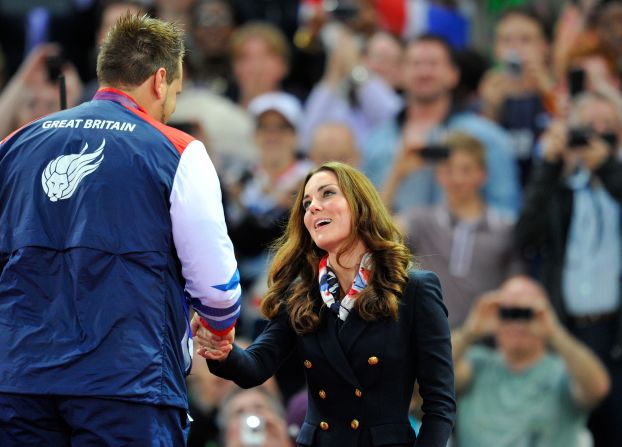 Catherine, Duchess of Cambridge, presents the gold medal to Aled Davies of Great Britain after he won the men's discus F42 athletics event.