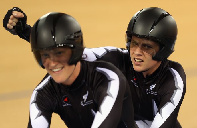 Laura Thompson, left, and Phillipa Gray of New Zealand celebrate winning a heat of the women's individual B pursuit track cycling event.