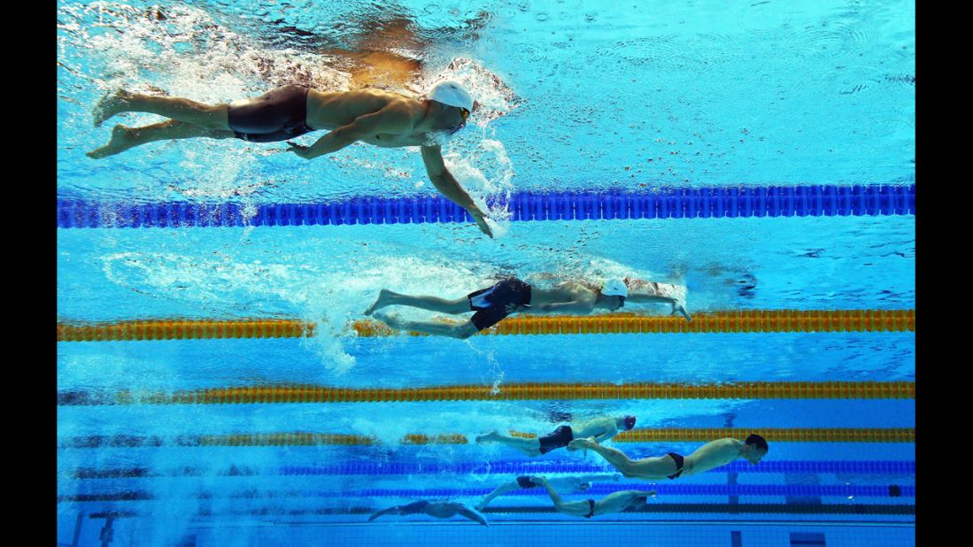 Swimmers compete in the men's 200-meter individual medley SM6 heat 2 at the Aquatics Center.