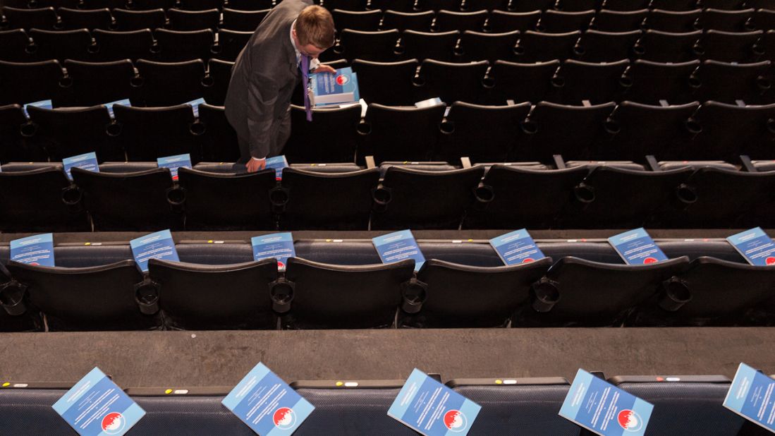 Brian Romanowski distributes delegate information packages inside the arena on Tuesday.
