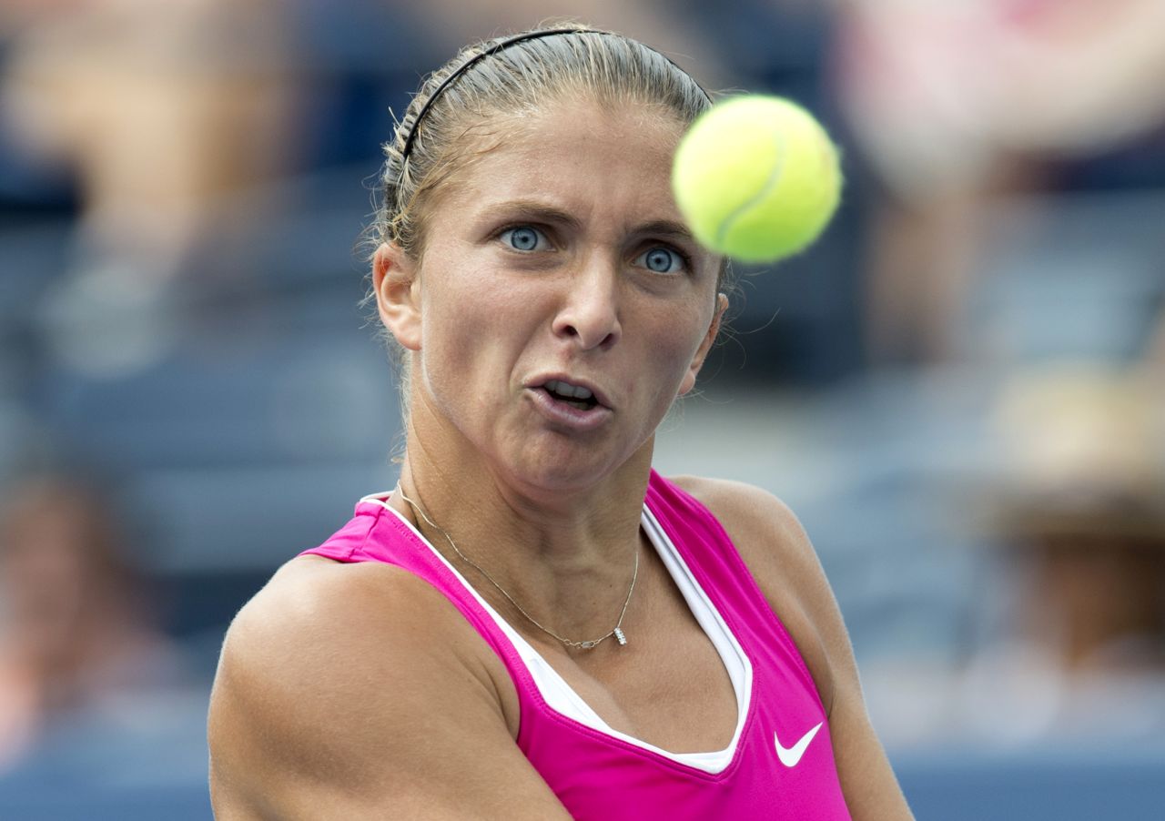 Sara Errani of Italy hits a return to Angelique Kerber of Germany during their women's singles match on Monday.