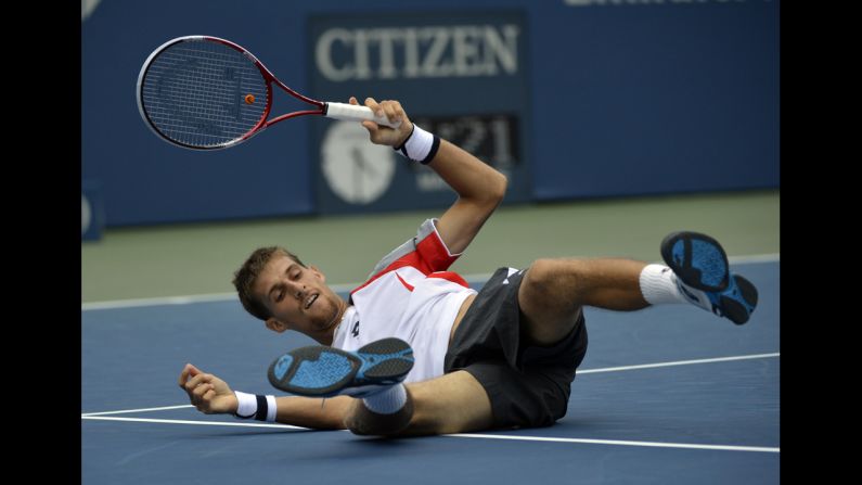 Martin Klizan of Slovakia takes a tumble Monday.