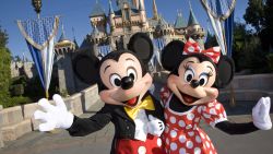 Mickey and Minnie Mouse in front of Sleeping Beauty Castle at Disneyland in Anaheim, California.