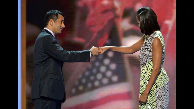 Michelle Obama and actor and former Obama administration aide Kal Penn bump fists after a rehearsal for her speech on Monday.