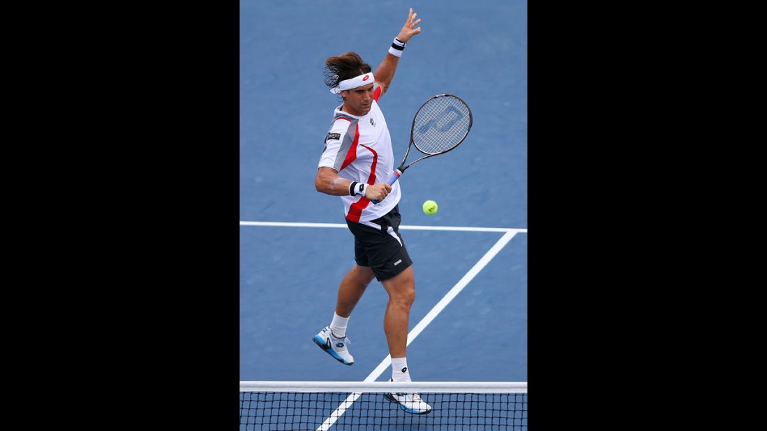 David Ferrer of Spain returns a shot against  Richard Gasquet of France during their men's singles fourth-round match on Tuesday.