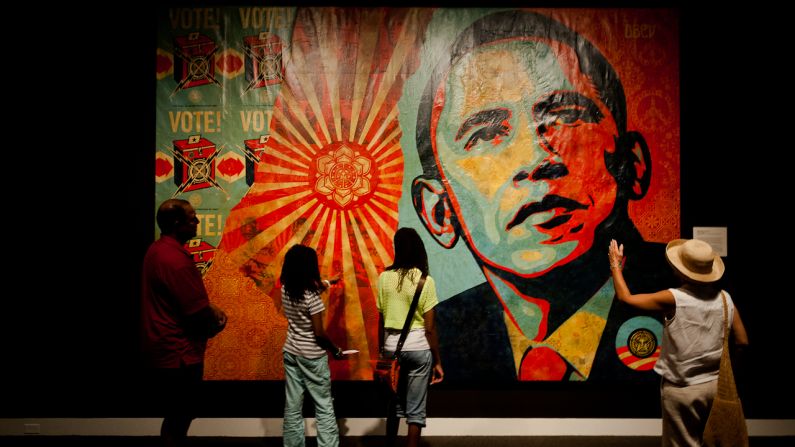 People stop to look at a mural by artist Shepard Fairey on Monday, September 3.