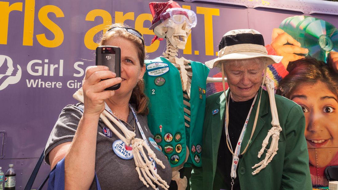 Sara Riley takes a picture Monday while she and her mother, Nan Riley, pose with a Girl Scouts skeleton.