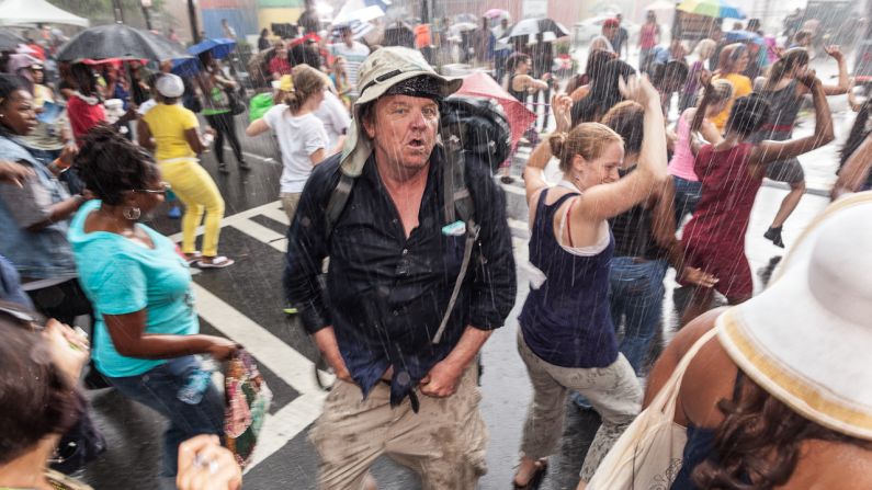 People dance in the rain Monday in the streets of Charlotte.