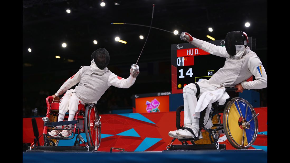 Chinese Daoliang Hu, left, on his way to winning gold against Ukrainian Anton Datsko on Tuesday during the men's final of wheelchair fencing.