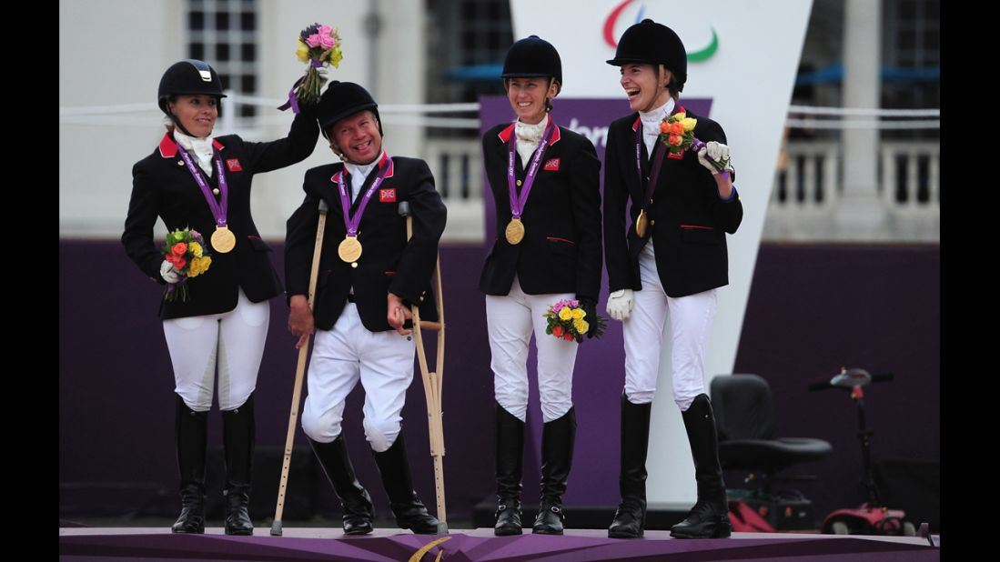 Sophie Wells, Lee Pearson, Deborah Criddle and Sophie Christiansen of Great Britain wear their team gold medals for the equestrian event on Tuesday.