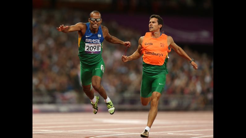 Daniel Silva of Brazil and guide Heitor de Oliveira Sales win silver in the men's 200-meter  - T11 final on Tuesday.