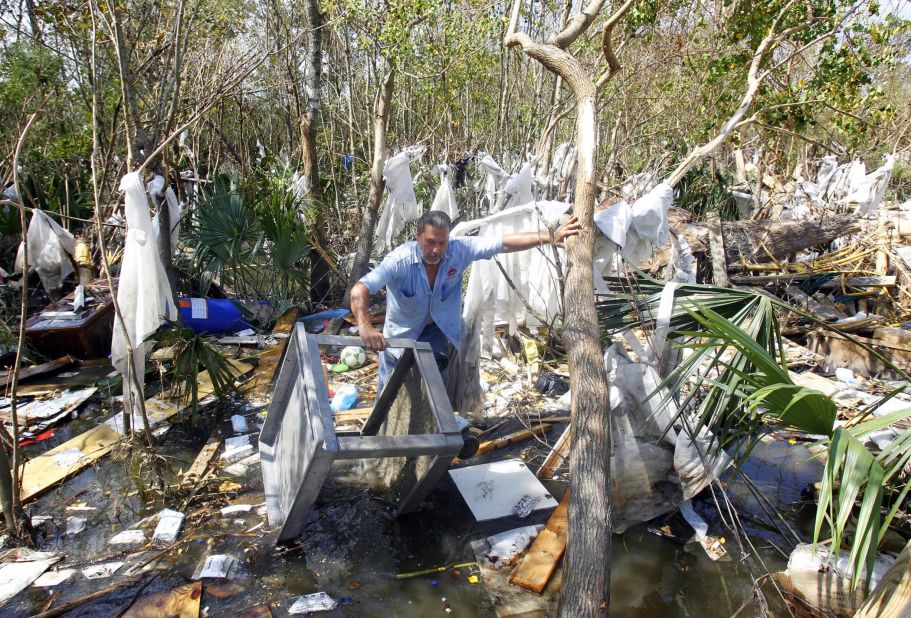 Louis Lipps tries to salvage belongings near his house on Lake Pontchartrain in LaPlace, Louisiana, on Tuesday, September 4.  Many residents returning to their homes in southern Louisiana after Hurricane Isaac will find little comfort. Authorities have blamed eight U.S. deaths on Isaac, six of them in Louisiana, after it made landfall last week as a Category 1 hurricane. 