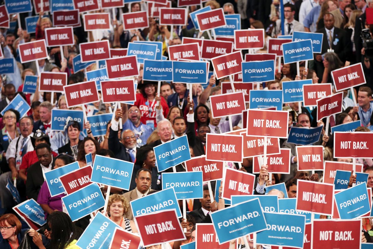 People hold signs Tuesday that read "Forward" and "Not Back."