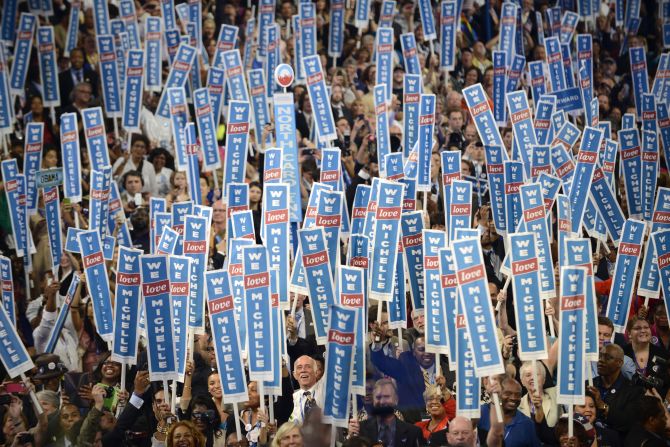 A sea of signs welcomes the first lady onto the stage Tuesday at the Time Warner Cable Arena.