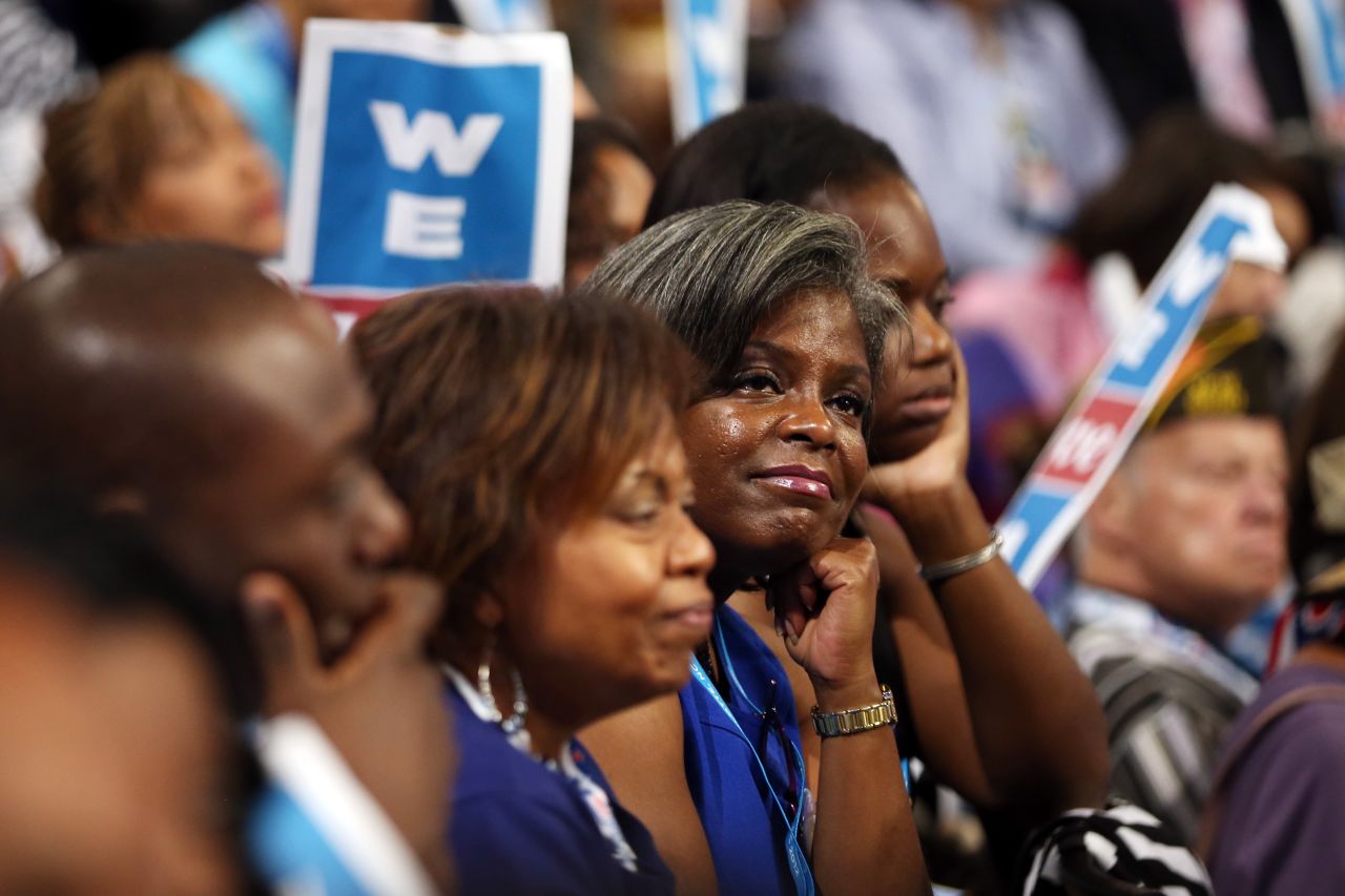 Delegates listen to Michelle Obama's speech Tuesday. The first lady offered a personal perspective on why her husband should be re-elected.