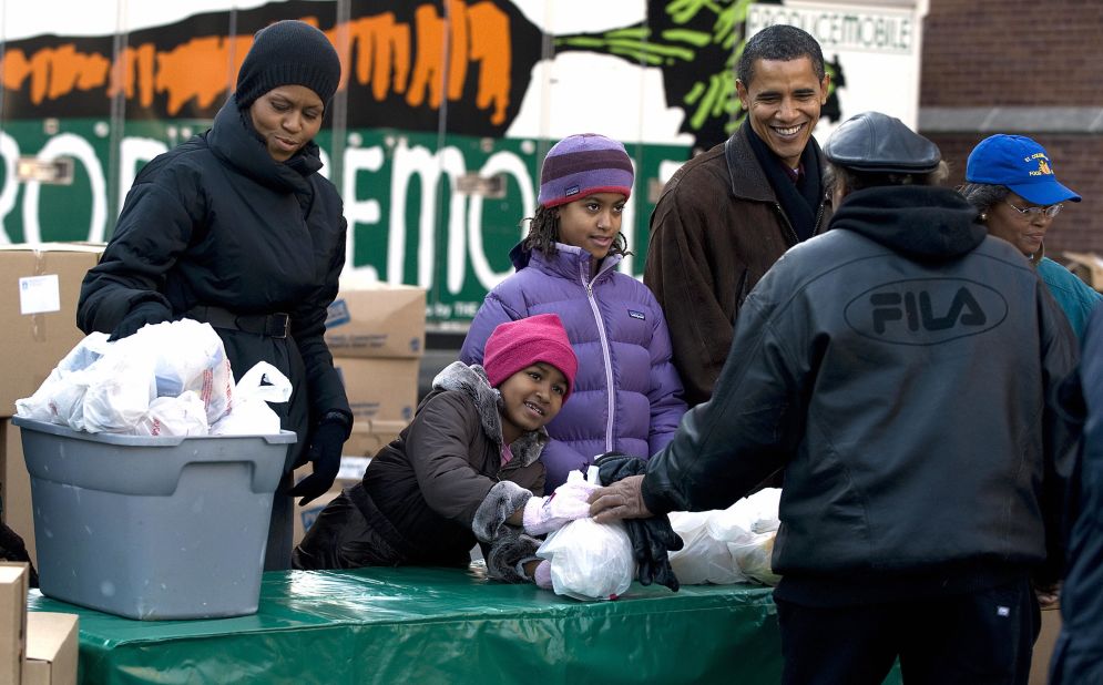The family hands out food for Thanksgiving in their hometown of Chicago in November 2008 shortly after Barack Obama's campaign victory.