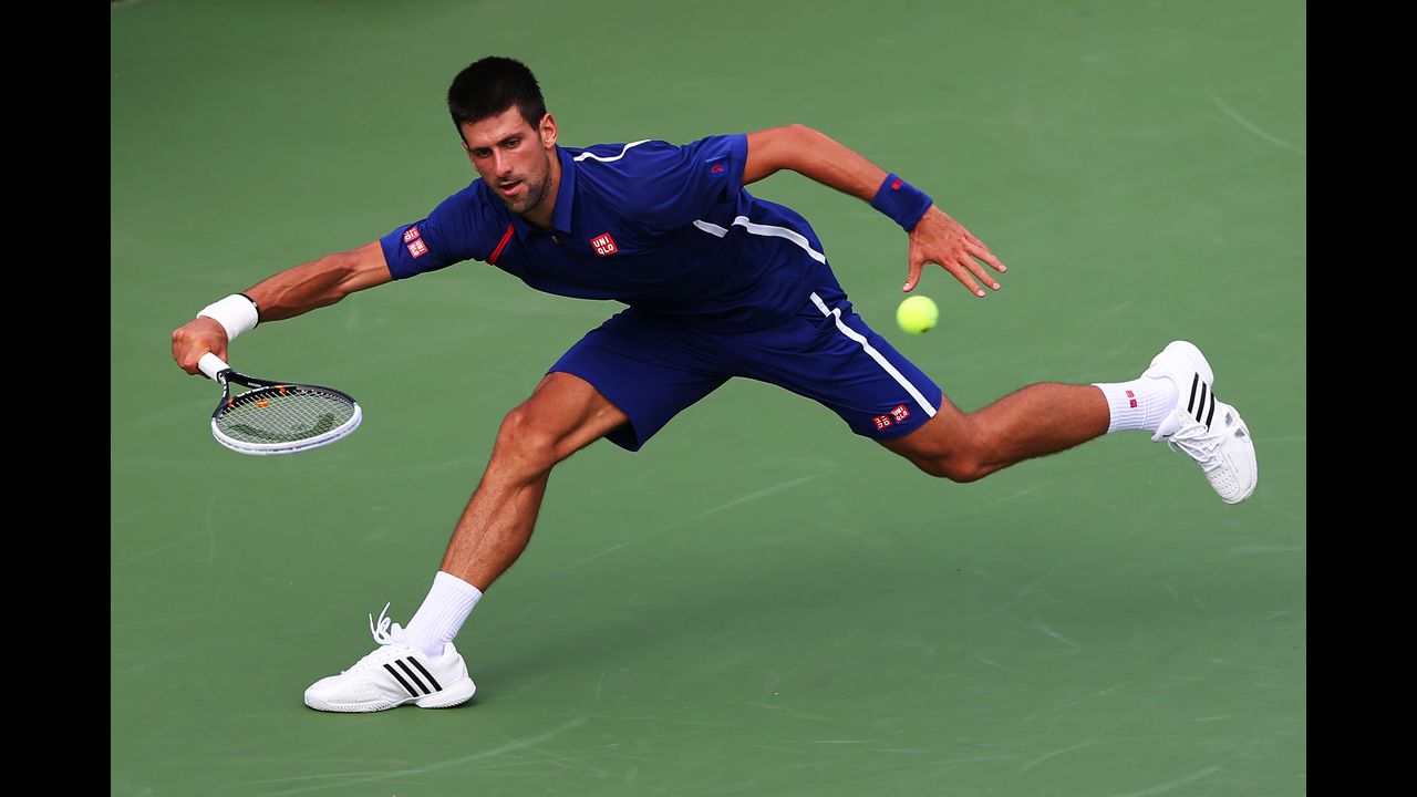 Serbia's Novak Djokovic pulls back to return a shot to Stanislas Wawrinka of Switzerland during his men's singles fourth-round match on Wednesday.