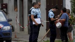Image #: 19263589    epa03384952 French Police officers talks with neighbors of the road leading the scene where four people died in a shooting at a parking in Chevaline near the Annecy Lake, France, 05 September 2012. The bodies of four people who had been shot dead were found in the French Alps, prosecutors said late 05 September, while a young girl survived the attack and was in a critical condition.  The bodies of a man and two women were found by a cyclist in a British-registered car in a secluded car park near Lake Annecy. The girl and the body of a male cyclist were found nearby. All had gun shot wounds.  EPA/NORBERT FALCO /LANDOV