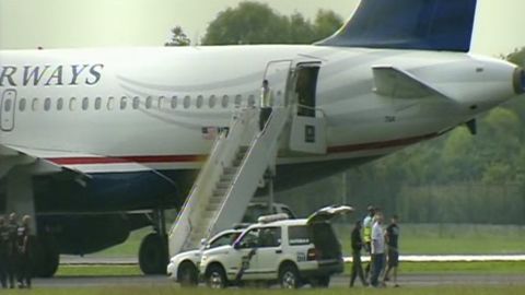 A US Airways plane bound for Dallas was diverted to Philadelphia, and a passenger was removed in handcuffs.