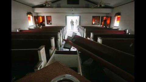 An insurance inspector tours the damaged Bethlehem Baptist Church on Tuesday.