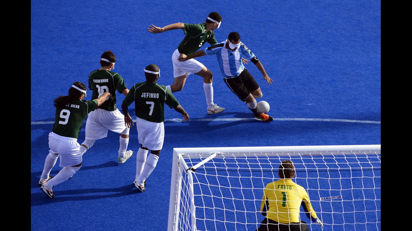 Argentina's captain Silvio Velo runs past Brazilian players to shoot at goal during the men's 5-a-side football semi-final match between Argentina and Brazil on Thursday.