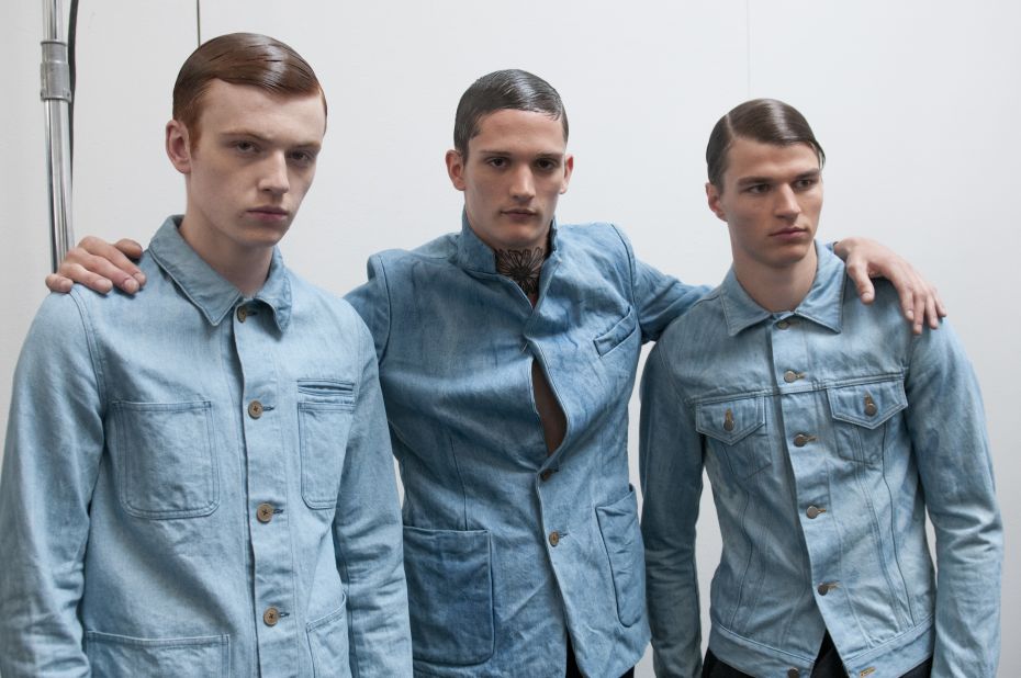 Three male models looking sleek backstage at the Duckie Brown Spring 2013 fashion show.